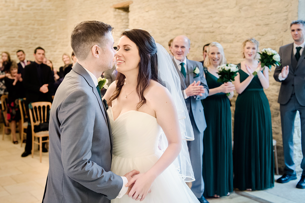 The first kiss is always a lovely shot at Kingscote Barn